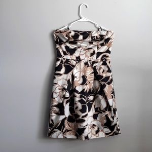 Floral black, white, and gold strapless Limited dress with pockets.